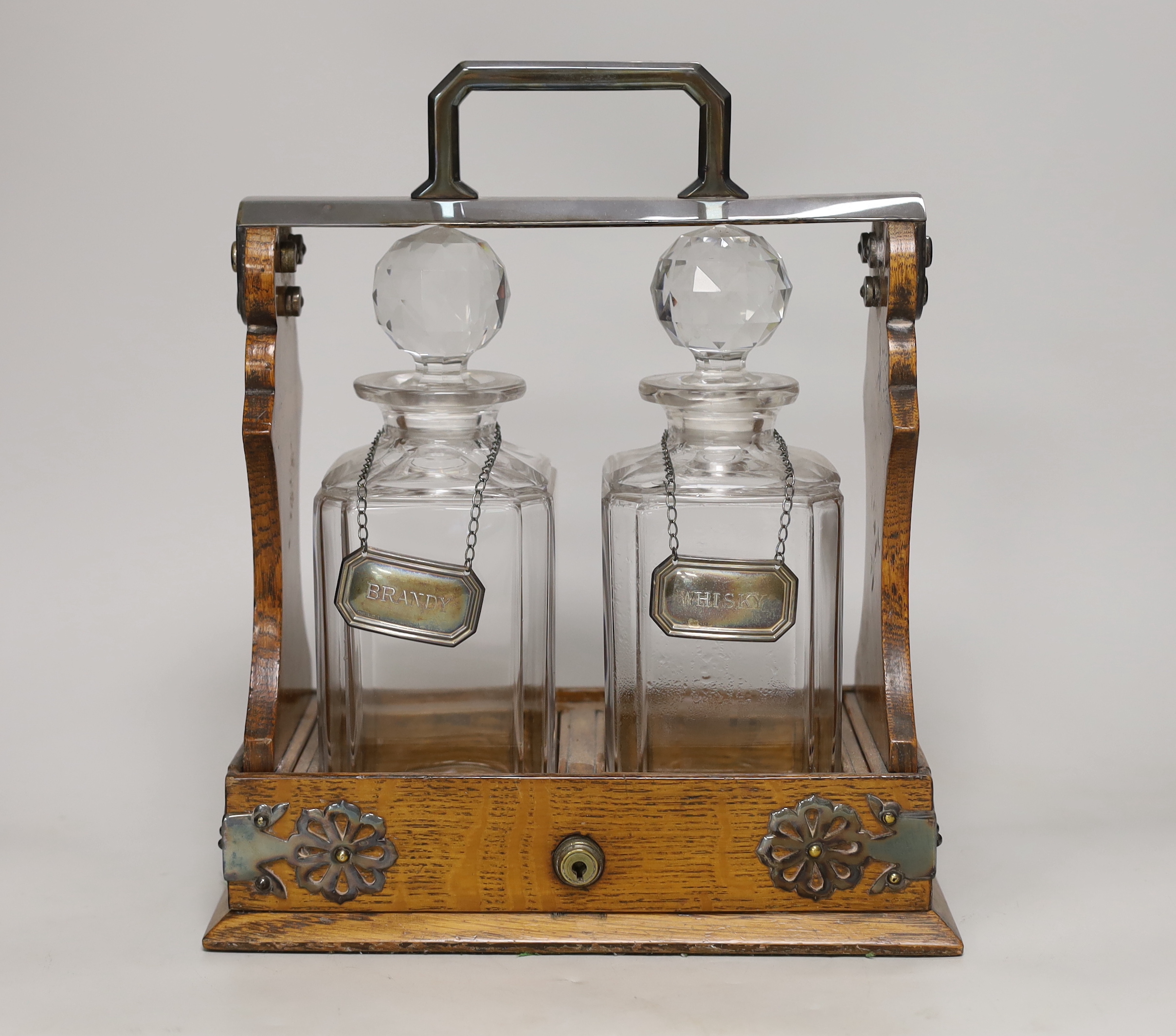 A Mappin Bros. oak and electroplate mounted two bottle tantalus, 31cm high